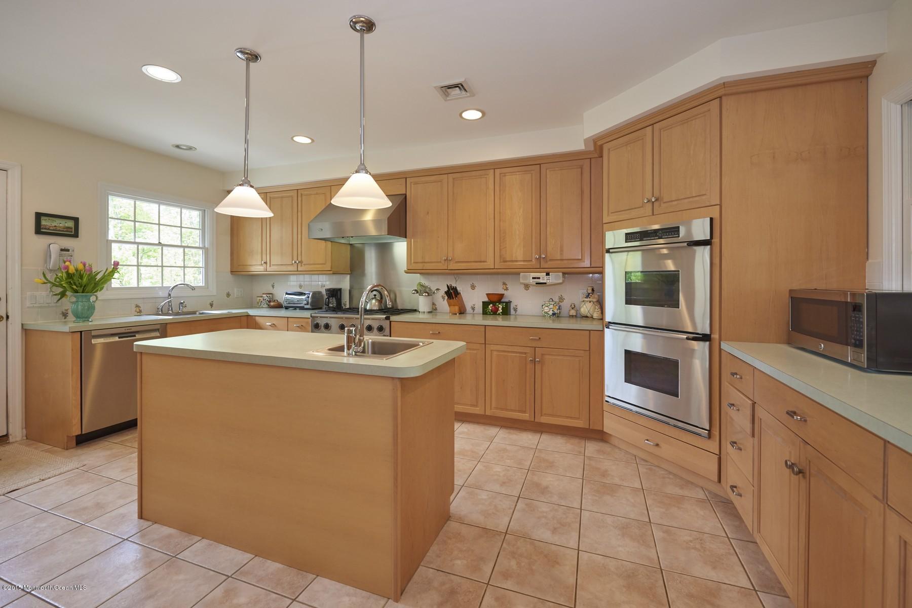150 Bowne Road Middletown, NJ 07716 - Photo 4 of 20 a kitchen with kitchen island granite countertop a sink counter top space cabinets and stainless steel appliances