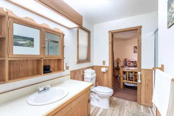 a bathroom with a sink a toilet and a mirror