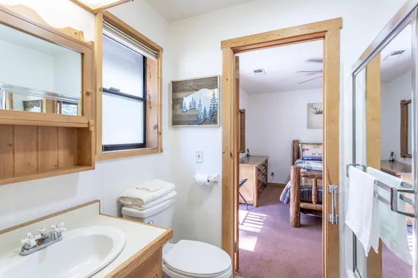a bathroom with a sink toilet and shower