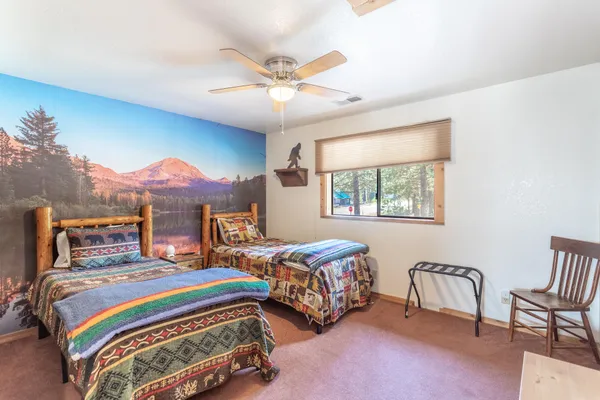 a bedroom with two beds and a window