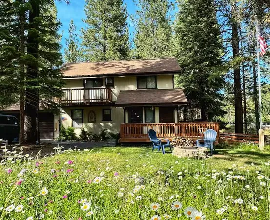 a view of an house with backyard space and sitting area