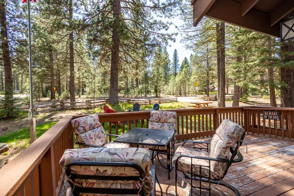 a view of a patio with furniture and a yard
