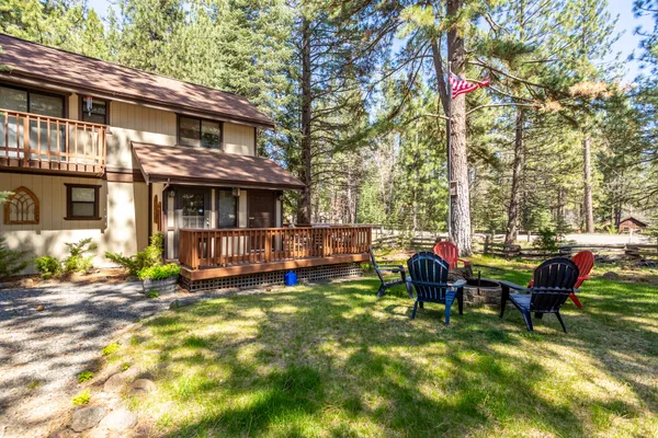 a view of a house with backyard porch and sitting area