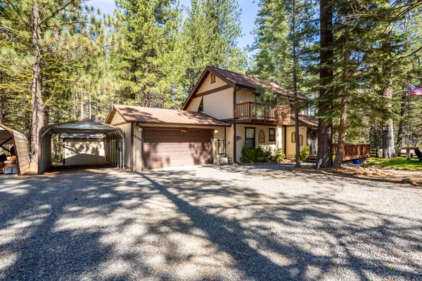 a view of a house with a yard and garage