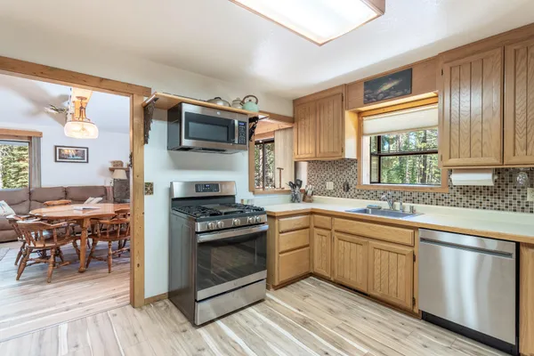 a kitchen with a stove a sink and a microwave