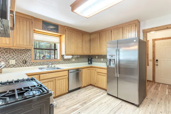 a kitchen with stainless steel appliances granite countertop a sink stove and refrigerator