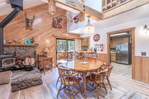 a dining area with furniture and wooden floor