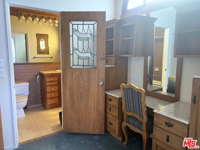 a view of hall way with furniture and wooden floor