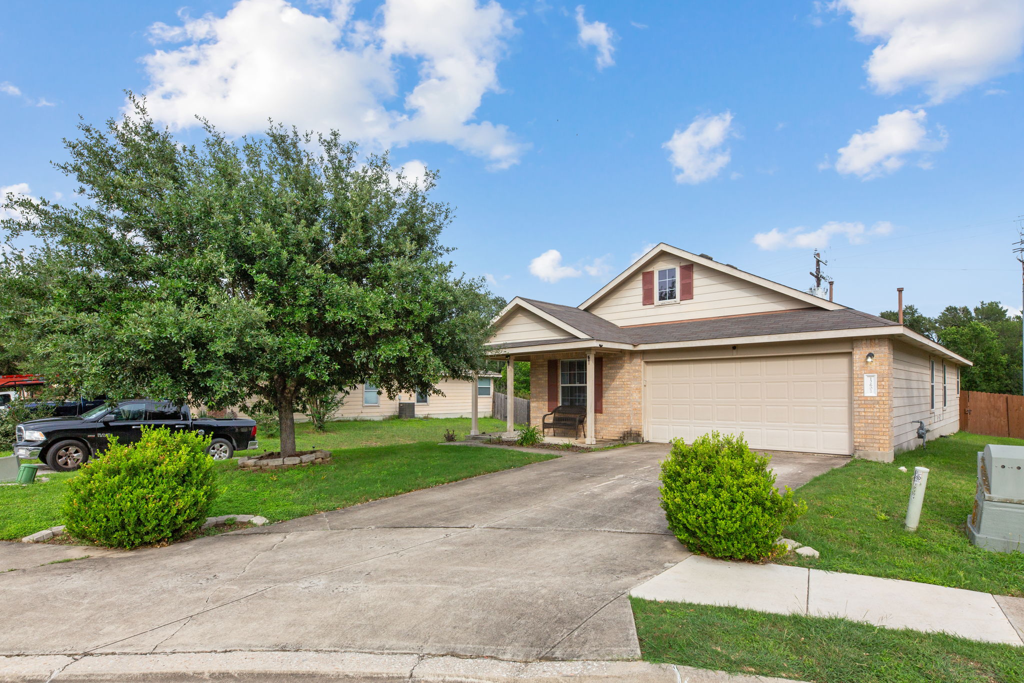12601 Waynespur Lane Elgin, TX 78621 - Photo 2 of 38 A well-maintained suburban dwelling with a convenient attached garage and welcoming covered entry.