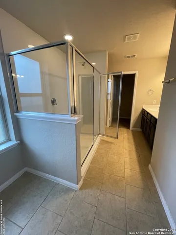 a bathroom with a sink vanity and a mirror