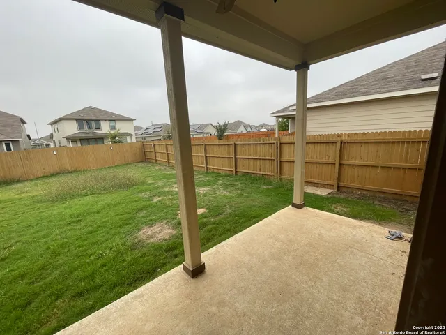 a view of a backyard with potted plants