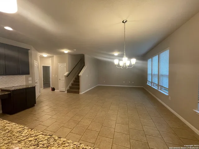 a view of a livingroom with a chandelier furniture and a flat screen tv