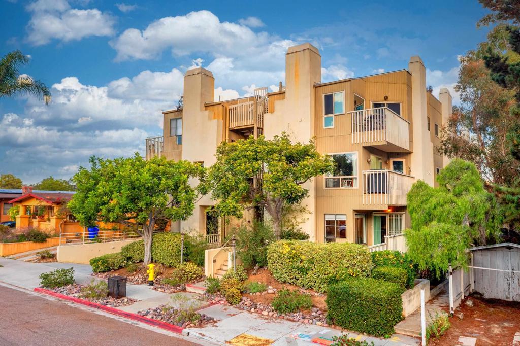 4055 Eagle Street, Unit 102 San Diego, CA 92103 - Photo 1 of 37 a front view of a residential apartment building with a yard and car parked