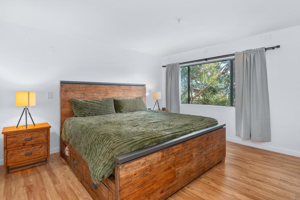 4055 Eagle Street, Unit 102 San Diego, CA 92103 - Photo 14 of 37 a bedroom with a bed and a night stand
