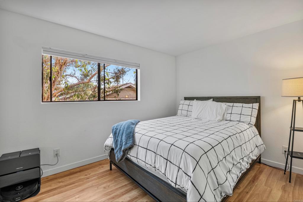 4055 Eagle Street, Unit 102 San Diego, CA 92103 - Photo 17 of 37 a bedroom with a bed and a window
