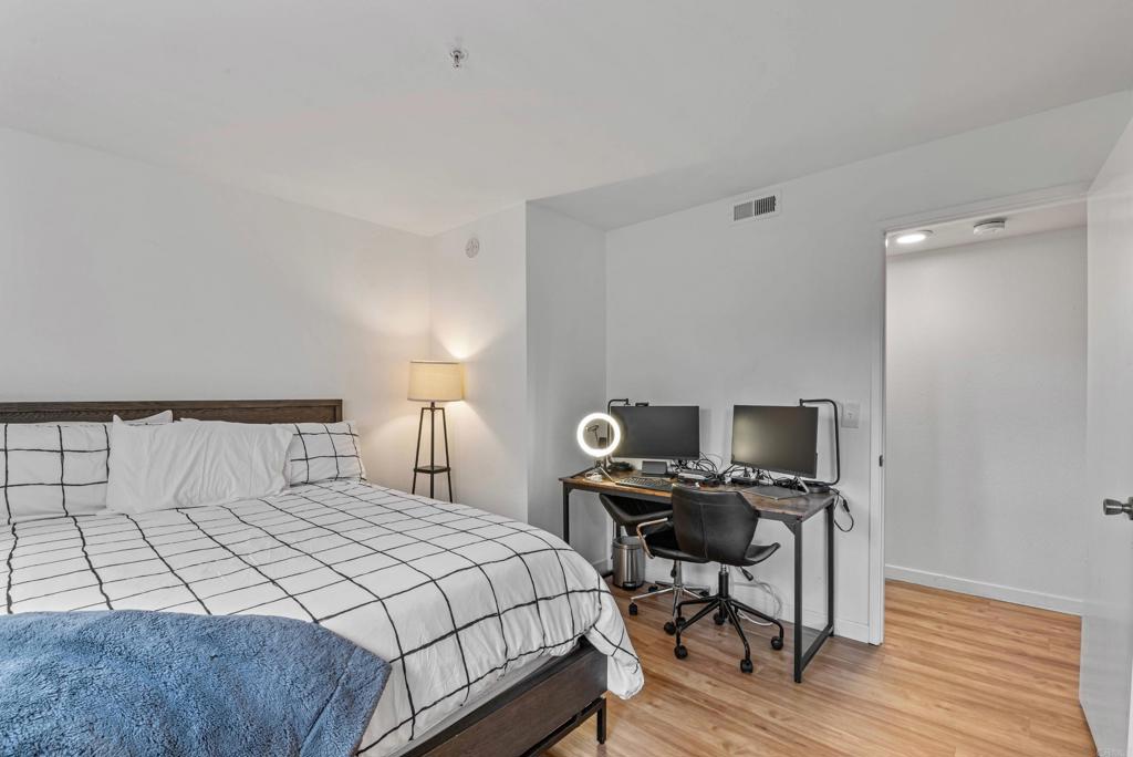 4055 Eagle Street, Unit 102 San Diego, CA 92103 - Photo 18 of 37 a bedroom with a bed and a desk