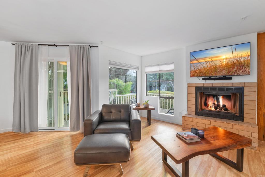 4055 Eagle Street, Unit 102 San Diego, CA 92103 - Photo 5 of 37 a living room with furniture and a fireplace