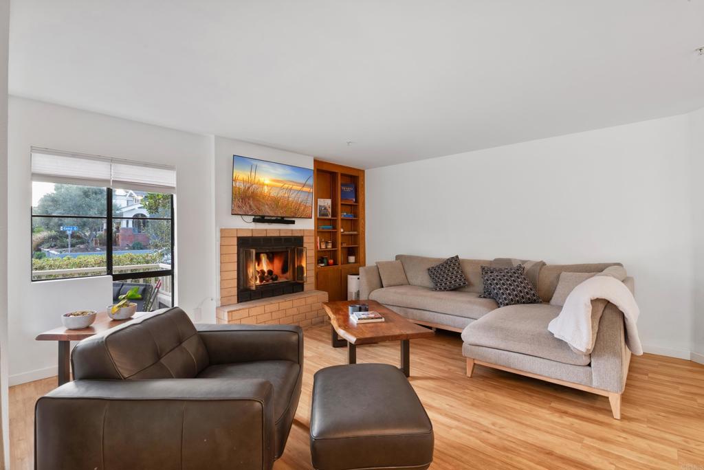 4055 Eagle Street, Unit 102 San Diego, CA 92103 - Photo 8 of 37 a living room with furniture and a fireplace