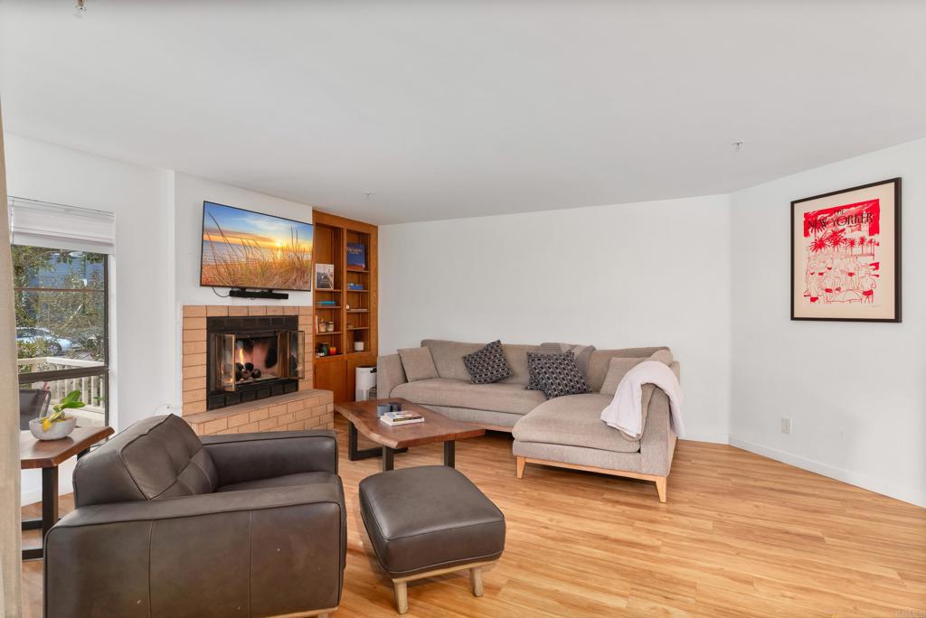 4055 Eagle Street, Unit 102 San Diego, CA 92103 - Photo 9 of 37 a living room with furniture and a fireplace