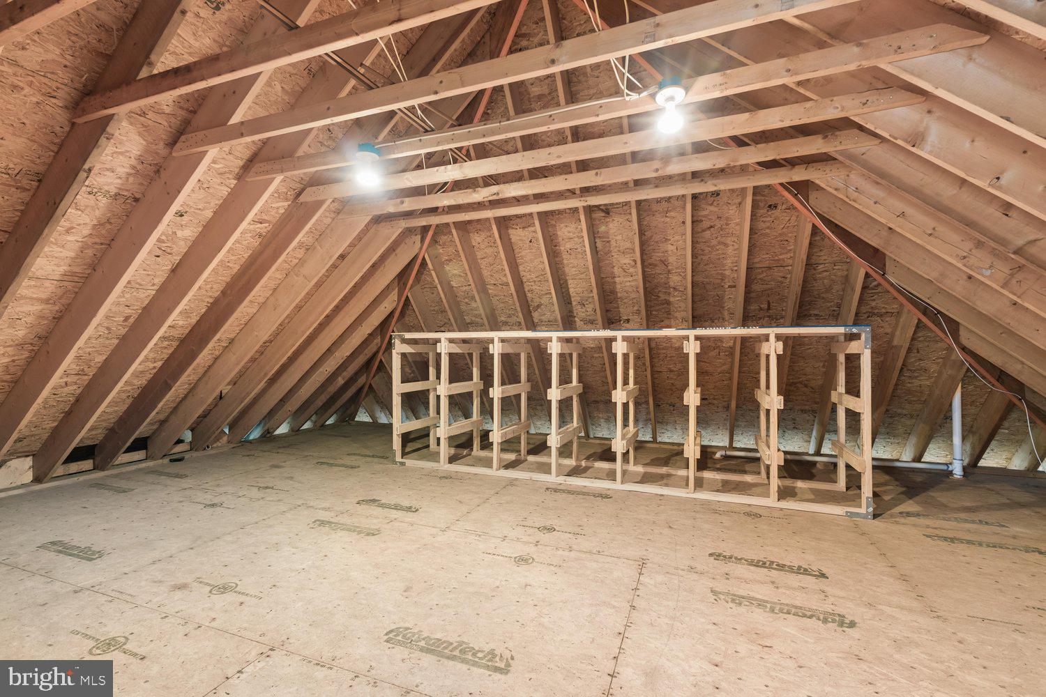 313 Wye Road Queenstown, MD 21658 - Photo 126 of 132 Spacious attic with exposed beams and lighting.