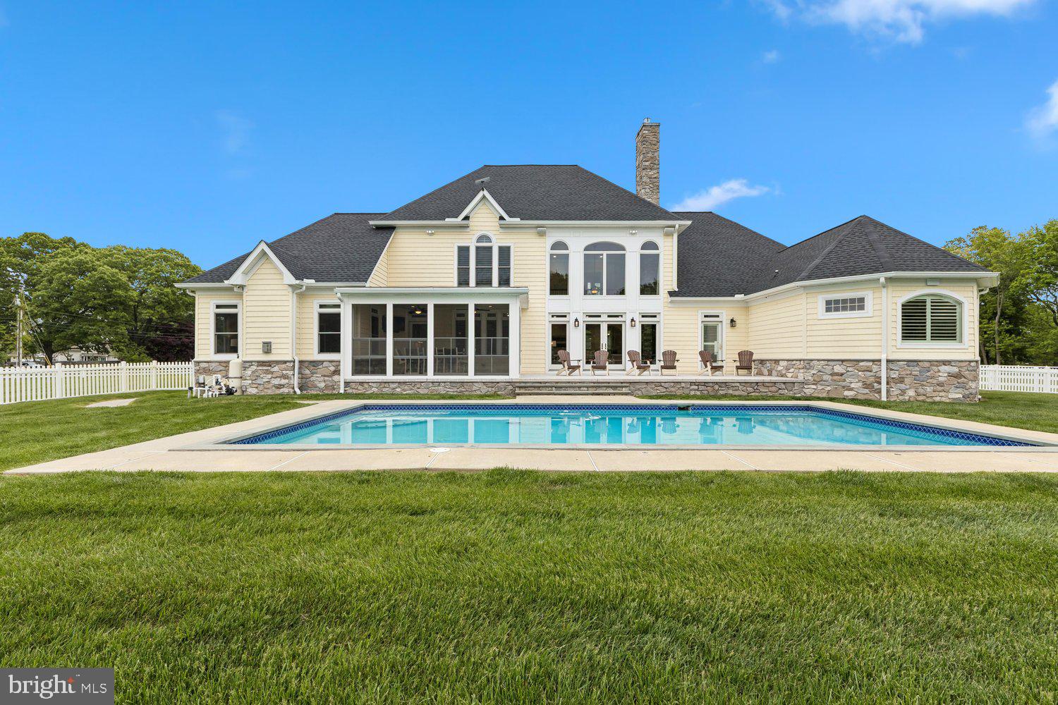 313 Wye Road Queenstown, MD 21658 - Photo 19 of 132 Elegant home with pool and lush greenery.