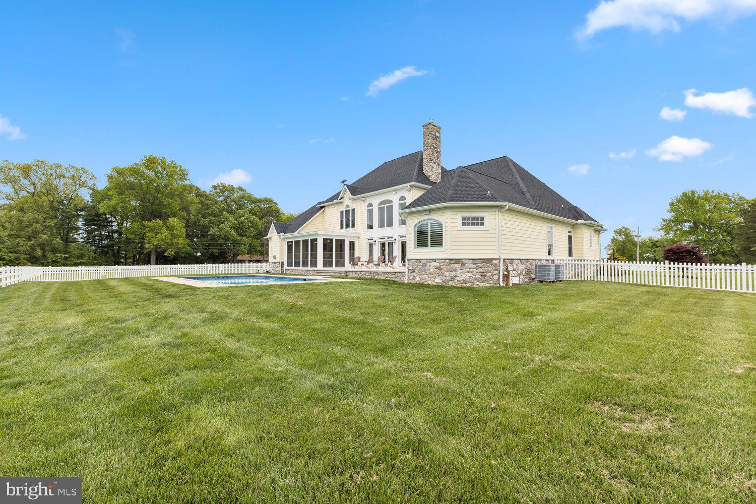 313 Wye Road Queenstown, MD 21658 - Photo 20 of 132 Elegant home with pool and lush greenery.