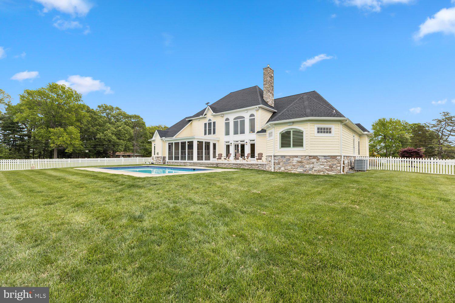 313 Wye Road Queenstown, MD 21658 - Photo 21 of 132 Elegant home with pool and lush greenery.