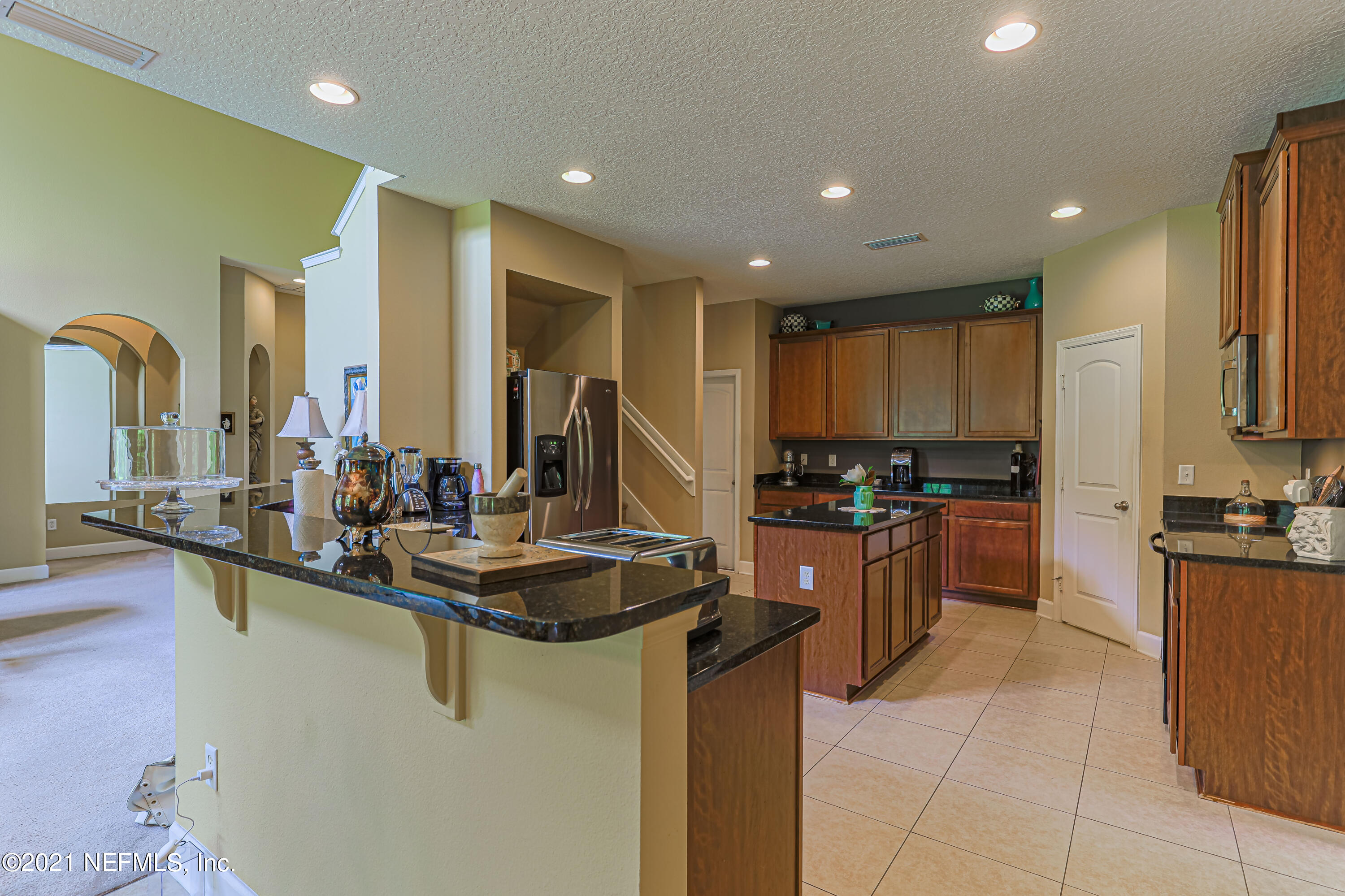 132 North Atherley Road St. Augustine, FL 32092 - Photo 11 of 40 a kitchen with kitchen island granite countertop a sink counter top space appliances and cabinets