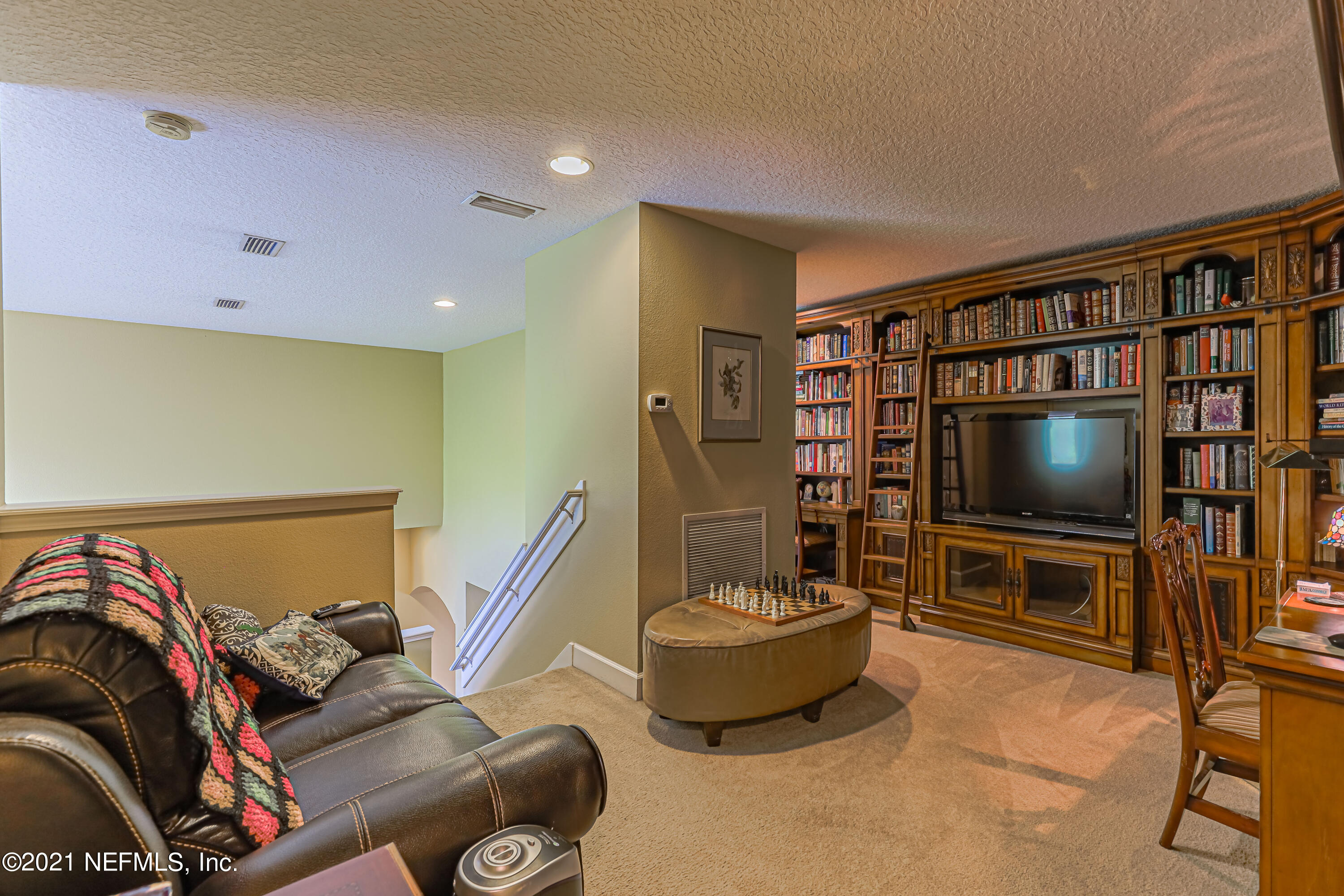 132 North Atherley Road St. Augustine, FL 32092 - Photo 20 of 40 a living room with furniture and a flat screen tv