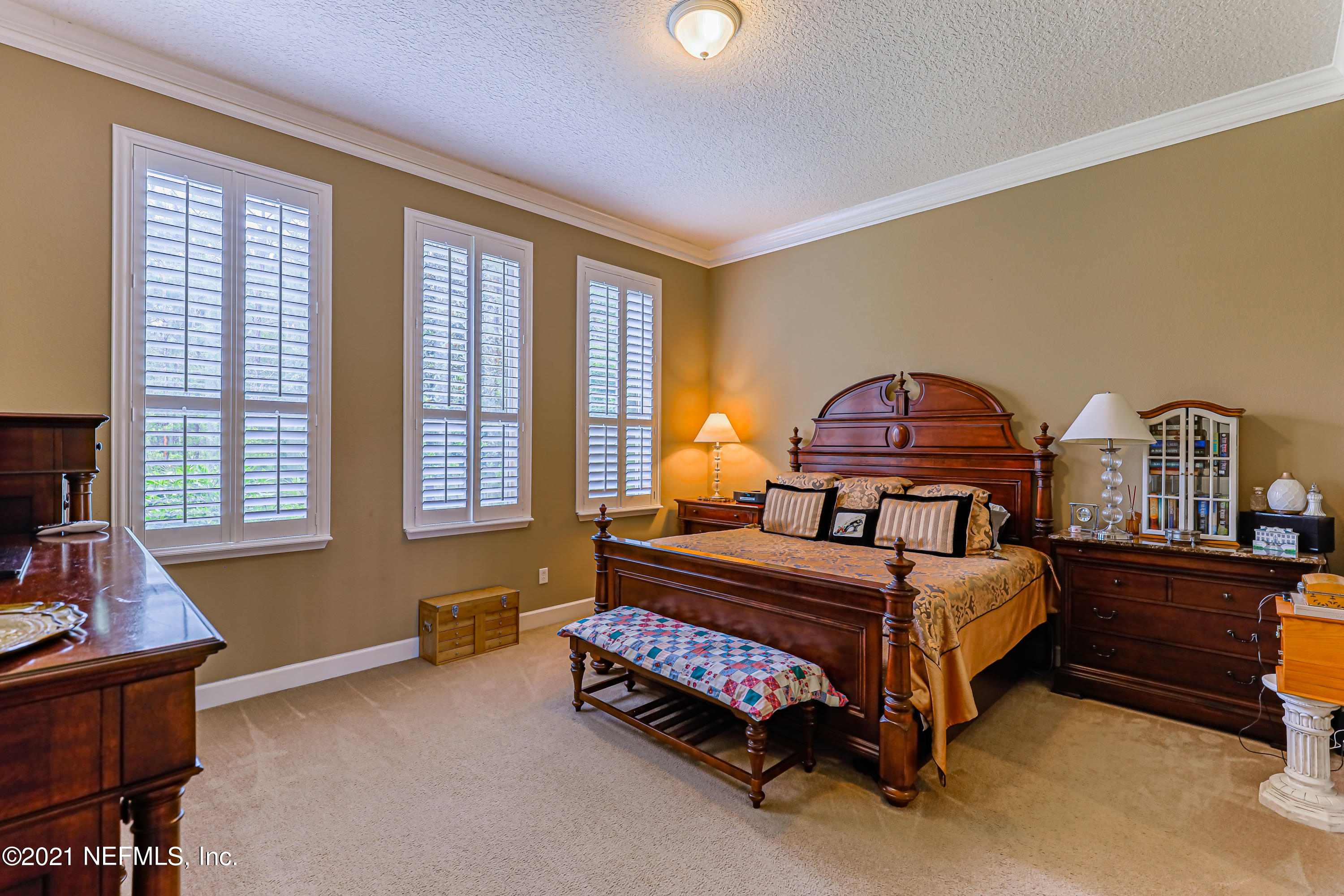 132 North Atherley Road St. Augustine, FL 32092 - Photo 22 of 40 a bedroom with a bed and a printing on the wall