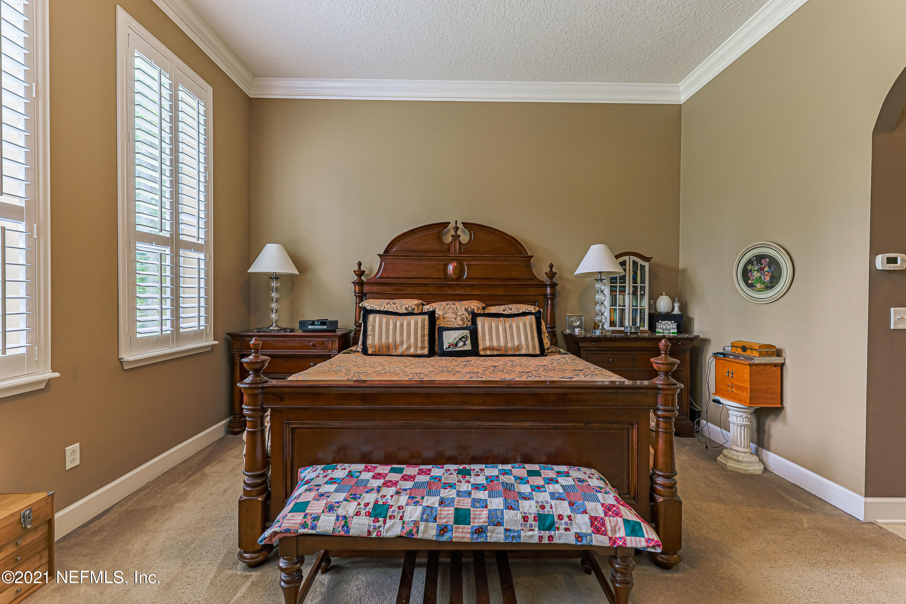 132 North Atherley Road St. Augustine, FL 32092 - Photo 23 of 40 a bedroom with a bed a mirror and a window
