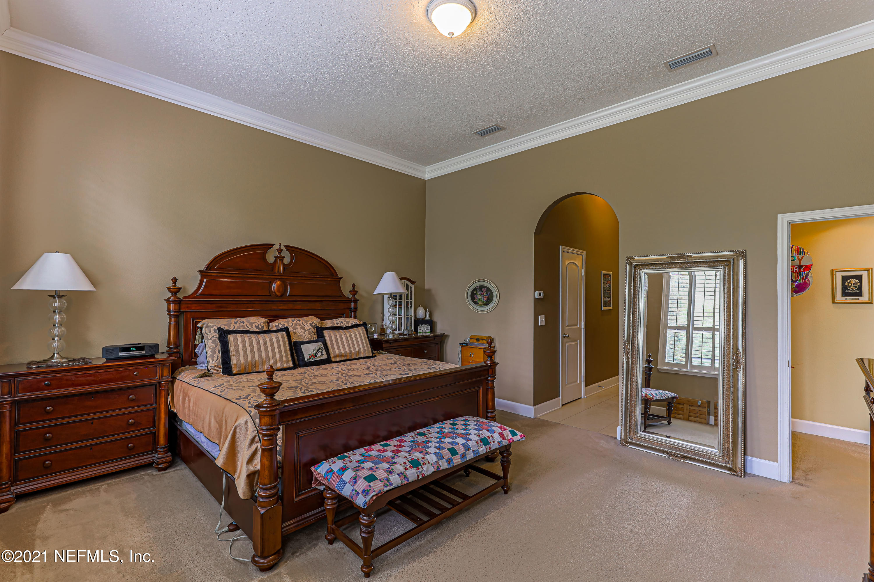 132 North Atherley Road St. Augustine, FL 32092 - Photo 24 of 40 a bedroom with a bed and a chandelier