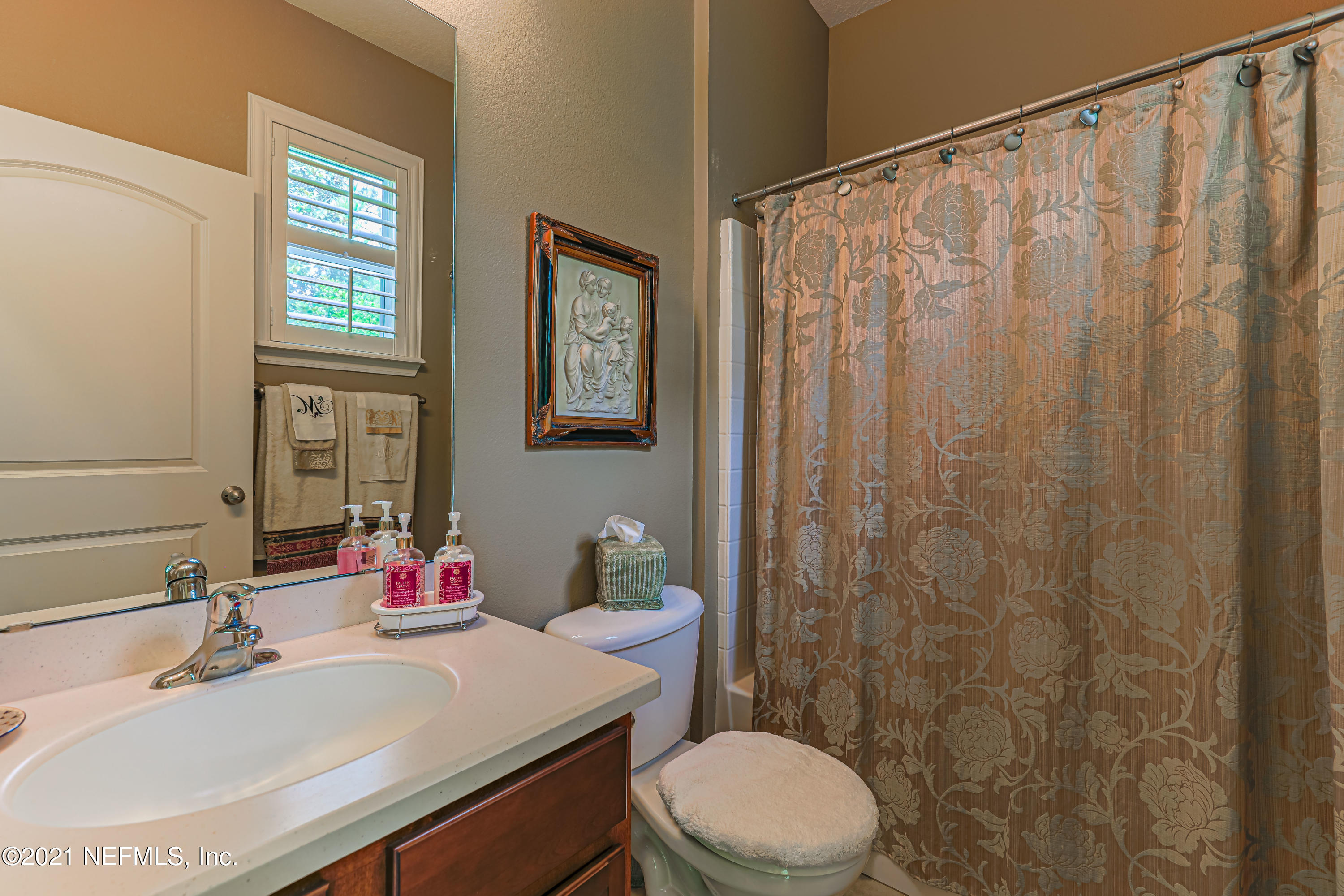 132 North Atherley Road St. Augustine, FL 32092 - Photo 29 of 40 a bathroom with a sink a toilet and shower curtain