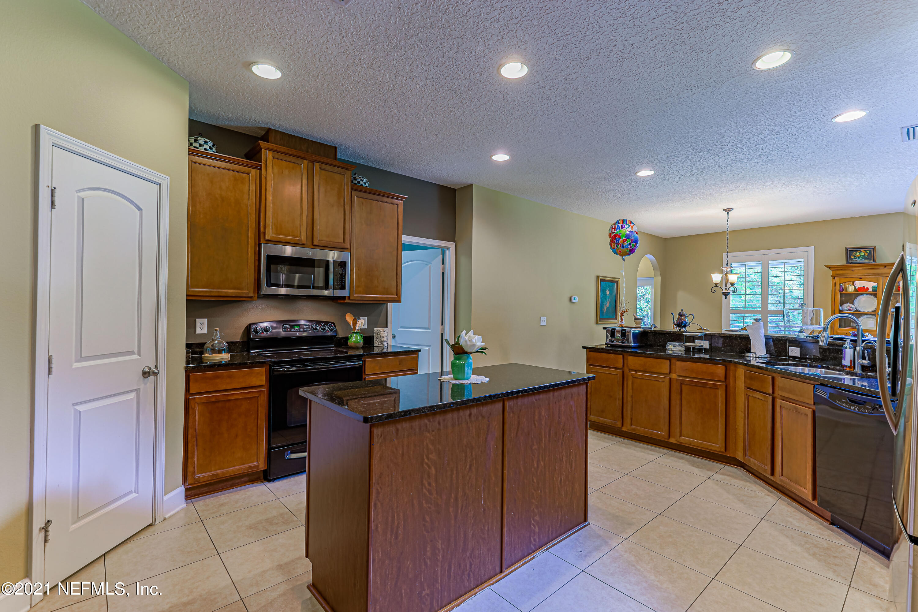 132 North Atherley Road St. Augustine, FL 32092 - Photo 10 of 40 a kitchen with stainless steel appliances granite countertop sink stove top oven and refrigerator