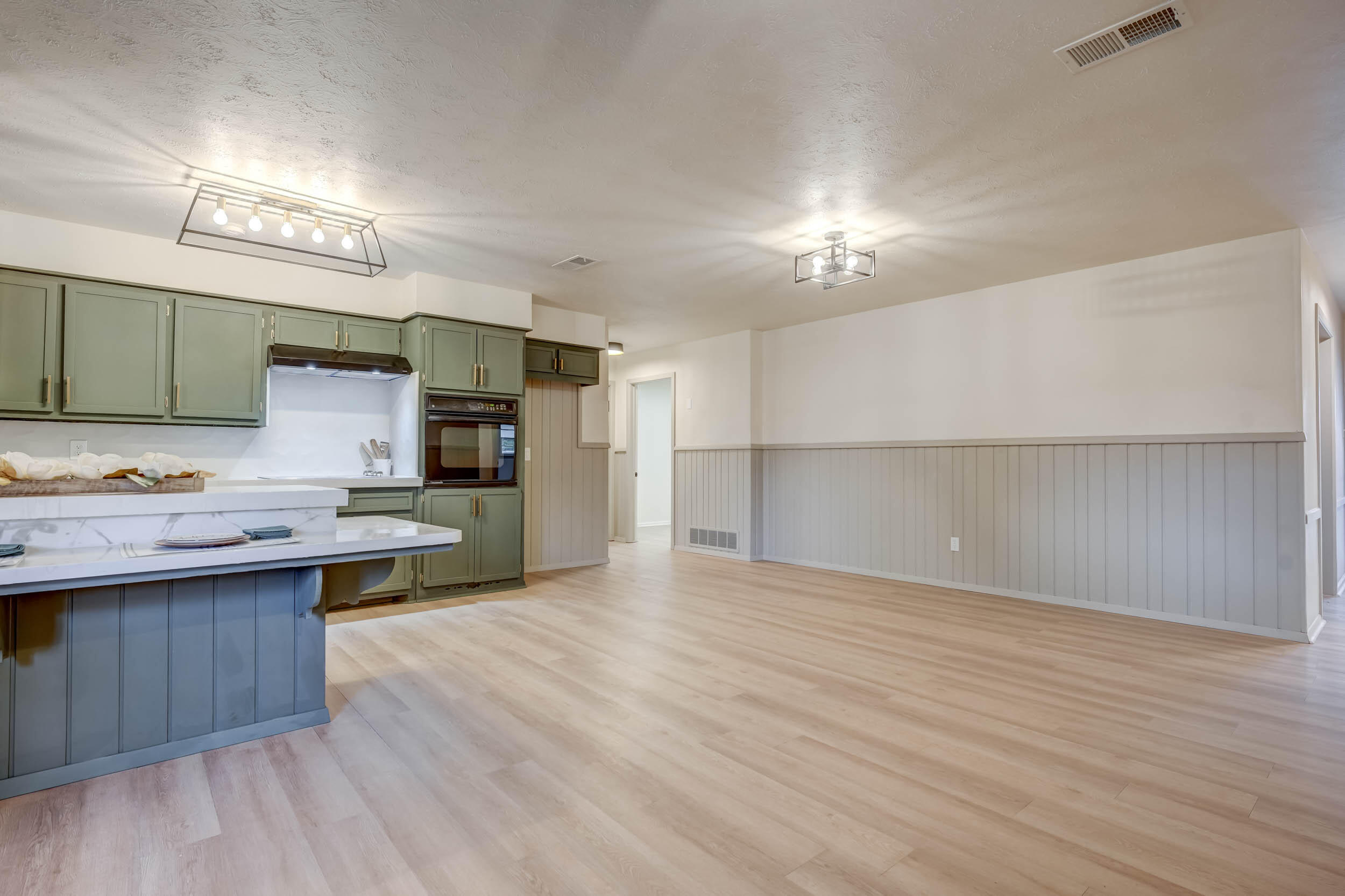 2101 64th Street Lubbock, TX 79412 - Photo 17 of 30 a view of kitchen with cabinets and wooden floor
