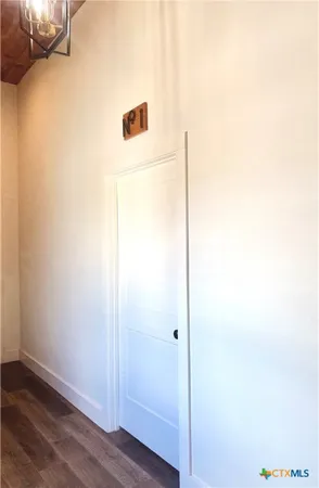 a kitchen with a refrigerator cabinets and wooden floor
