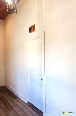 a kitchen with a refrigerator cabinets and wooden floor