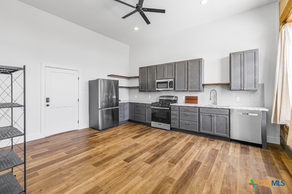123 West May Street, Unit 1 Yoakum, TX 77995 - Photo 13 of 21 a kitchen with stainless steel appliances a refrigerator sink and cabinets