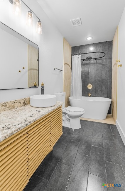 123 West May Street, Unit 1 Yoakum, TX 77995 - Photo 14 of 21 a bathroom with a sink a toilet and a bathtub