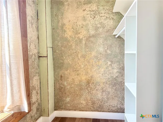 a view of a room with wooden floor and shower