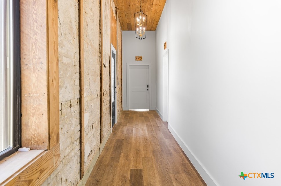 123 West May Street, Unit 1 Yoakum, TX 77995 - Photo 10 of 21 a view of a hallway with wooden floor