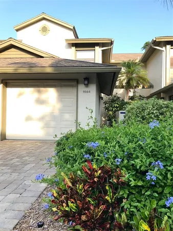 a front view of a building with parked cars