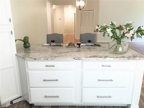 a living room with furniture floor to ceiling window and wooden floor
