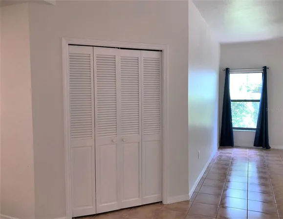 a bedroom with a bed lamp and a dresser