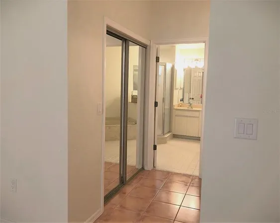 an empty room with a wooden floor and sliding window