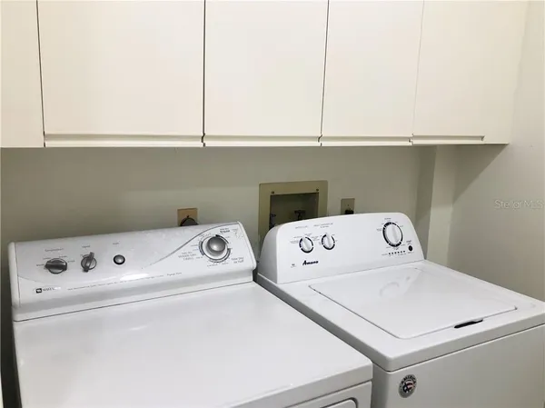 a view of a patio with swimming pool table and chairs