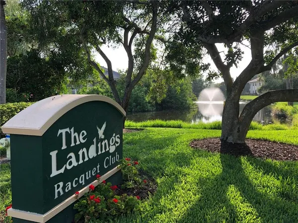 a view of a patio with couches table and chairs with wooden floor and fence
