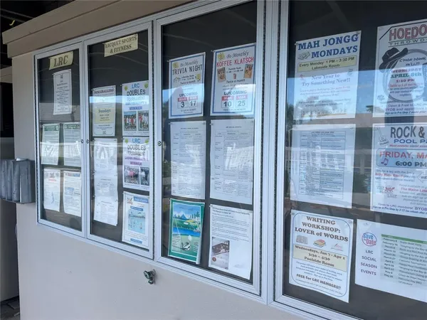 a kitchen with a refrigerator a microwave a sink and cabinets