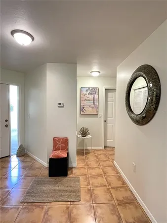 a view of a kitchen with dining area granite countertop a refrigerator and a stove top oven