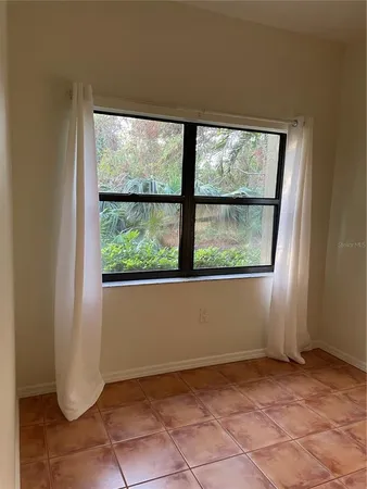 a kitchen with granite countertop a refrigerator and a stove top oven